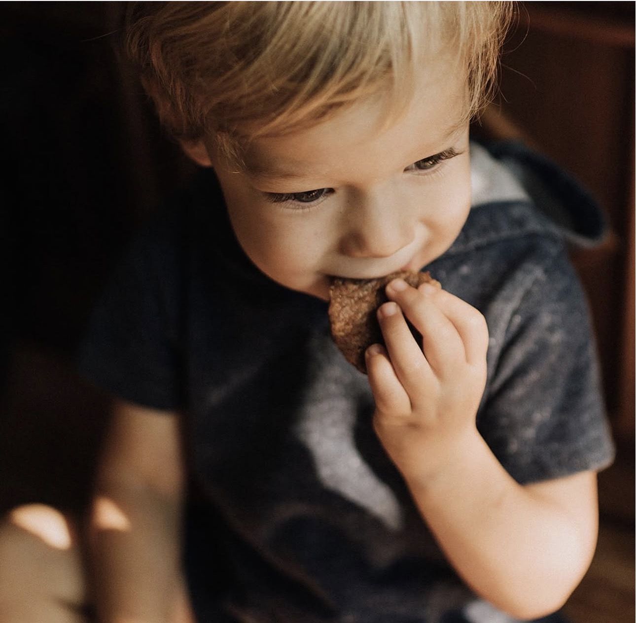 A child enjoying a homemade treat from Tidbits Home Bakery